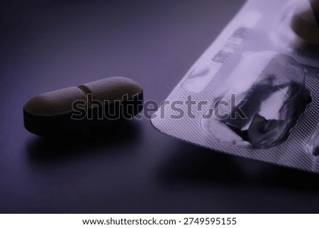 Pill tablet and empty blister pack suggesting drug addiction and pharmaceutical dependence