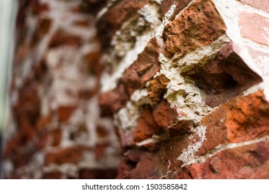 pillar, part of an antique building with a crumbling brick. close up
