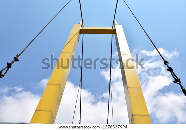 A pillar with steel cables of the\
bridge over the river at Samutprakan,\
Thailand.