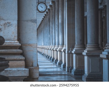 Pillars in a building with a clock.