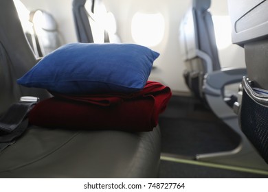 Pillow And Blanket Lying On The Seat In The Plane