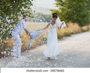 Pillow Fight. Bridal Couple Playing With Feathers