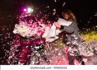 Pillow Fight. People Shots While They Are Having Pillow Fights. Feathers Are On Air. The Floor Is Covered By Feathers. No Faces