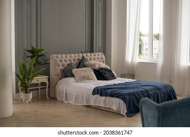Pillows closeup in nicely decorated bedroom in blue and white colors