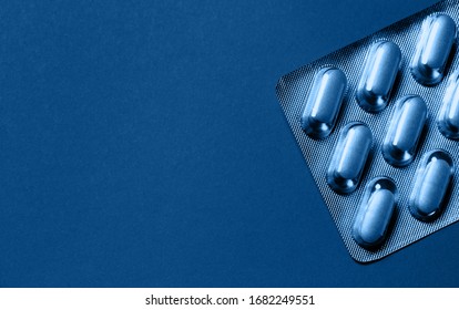 Pills in blister close up. Health care theme concept. Abstract background for blogs and web design. Selective focus. Toned in blue - Powered by Shutterstock