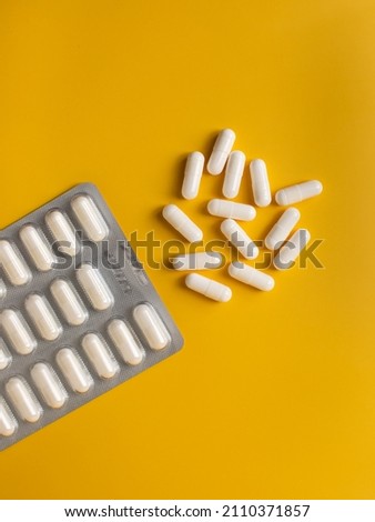 Pills and blister from pills on a bright background. Medicine, health, disease.