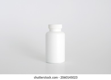 Pills Bottle. White Medical Container For Drugs, Diet, Nutritional Supplements. White Plastic Jar For Pills. Packaging Mockup Template. Free Space, Copy Space.