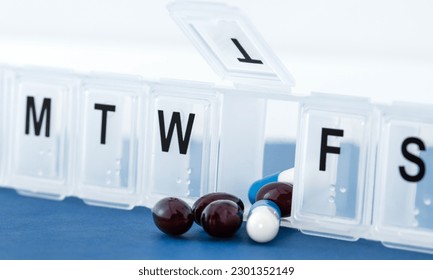 Pills in a box, a weekly container of tablets, vitamins.