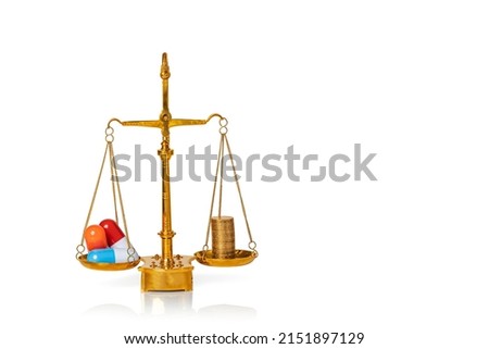 Pills. Capsules and coins on weighing scales isolated on white background. Medical concept. Copy space.
