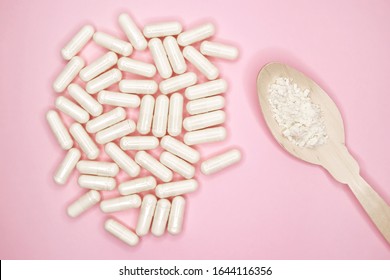 Pills capsules with colostrum, on a pink background