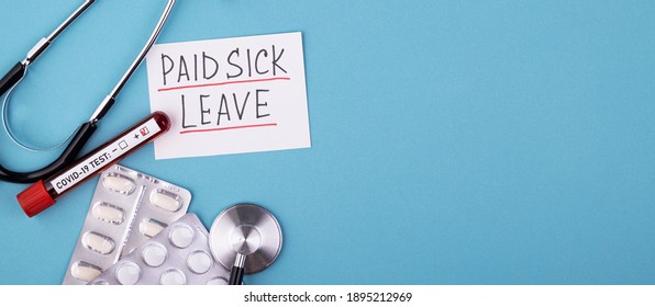 Pills, Covid Test And A Medical Phonendoscope With The Inscription Paid Sick Leave On A Blue Background. FMLA Family Medical Leave Act