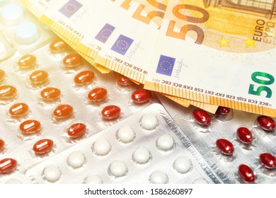 Pills Of Different Colors On Money. Medicine Concept. Euro Cash. Rising Cost Of Health Care With Spilled Medicine. Drug Abuse. Addiction.