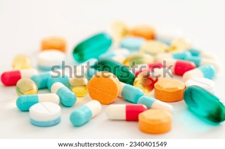 Pills, different colors, with selective focus.