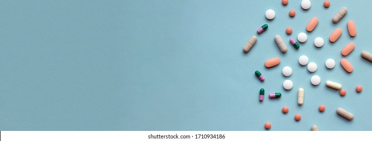 Pills, Drugs And Medicine On Blue Background, Pharmaceutical Treatment Banner With Copy Space