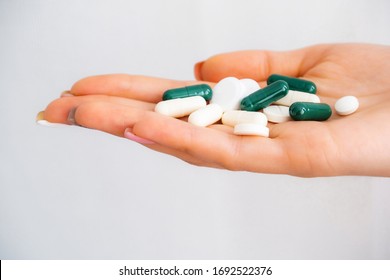 Pills In Hand Close Up On A White Background. Weightloss Remedy. Pills For Memory. Coronavirus Treatment. Cough Tablets. Pneumonia.