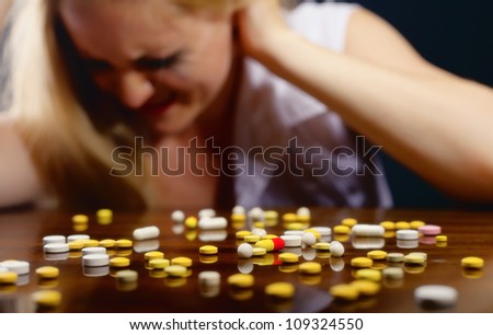 Pills lying on the table before suffering from the pain the young woman