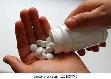 Pills Medication With Packaging On Hand For Oral Administration