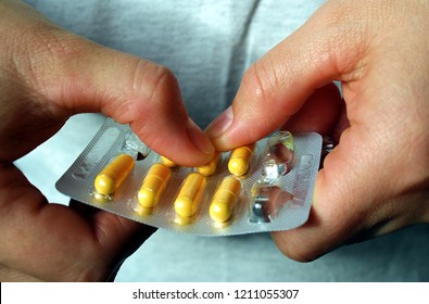 Pills Medication With Packaging On Hand For Oral Administration