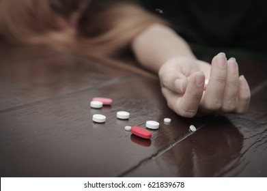 Pills on female hands , Suicide concept