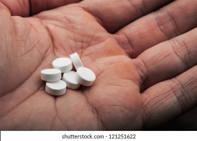 pills on the hand of man