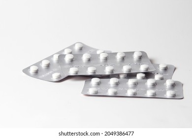 Pills In Pill Packs Placed On A White Table.