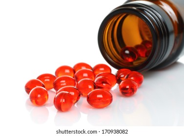 Pills pouring from white bottle on white background  