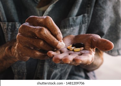 Pills In A Senior's Hands. Painful Old Age. Caring For The Health Of The Elderly