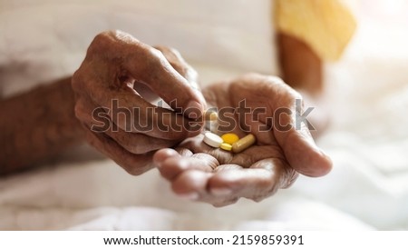 pills in a Senior's oldman hands. Painful old age. Caring for the health of the elderly

