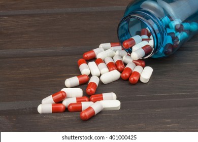 Pills Spilling From An Open Bottle. Doping In Sport. Abuse Of Anabolic Steroids For Sports. Anabolic Steroids Spilled On A Wooden Table. Food Supplements In The Diet.