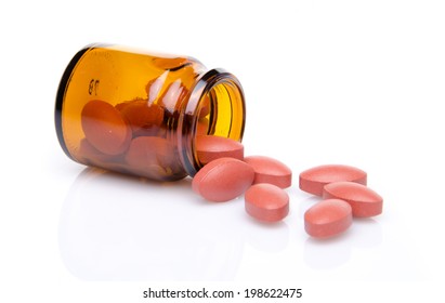 Pills Spilling Out Of Pill Bottle, Isolated On White