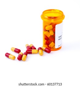 Pills Spilling Out Of Pill Bottle Isolated On White.