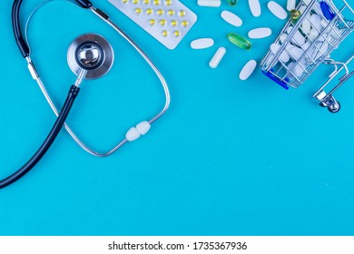 Pills And Stethoscope On Medical Desk Flat Lay Blue.