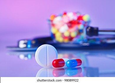 Pills And Tablets Macro Still Life On Violet, Medical Therapeutic Concept