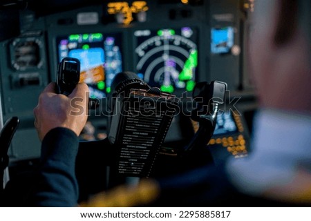 Pilot in airplane cockpit holding turning wheel rudder during flight Aviation concept