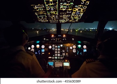 Pilot In Airplane Cockpit Night