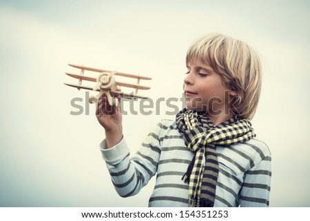 Pilot with airplane on a background of sky