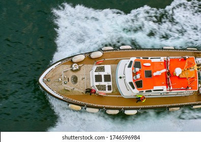 The Pilot Boat Accompanied By A Cruise Ship Sailing Along Orkney Islands. Orkney Islands, Scotland, UK