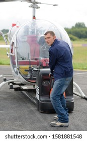 a pilot checking the helicopter