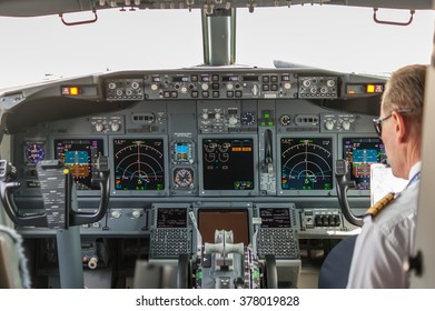 Pilot In The Cockpit Of A Passenger Plane