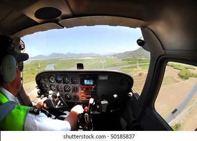 Pilot Landing A Small Plane On Cairns Airport, Australia After Scenic Flight