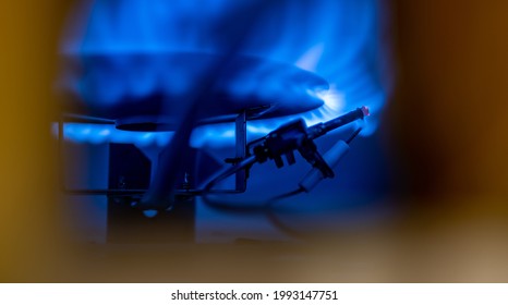 Pilot light auto igniter inside a hot water heater with flames