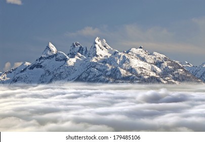 Pilot Mountains above clouds - in the Coast Mountain Range, British Columbia, Canada