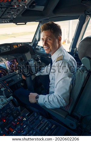 Pilot posing for the camera in the cockpit