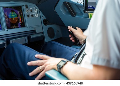 Pilot sitting in an aircraft cockpit.