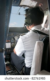 Pilot in a small plane cockpit preparing for Take-off