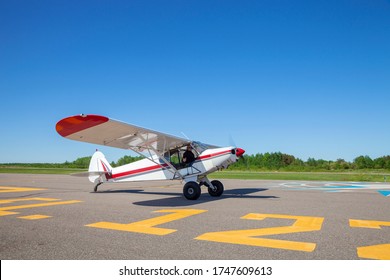 Pilot in small single engine plane taxis toward runway for take off