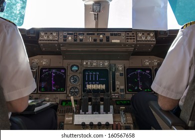 Pilots In The Boeing 747 Cockpit During A Commercial Flight