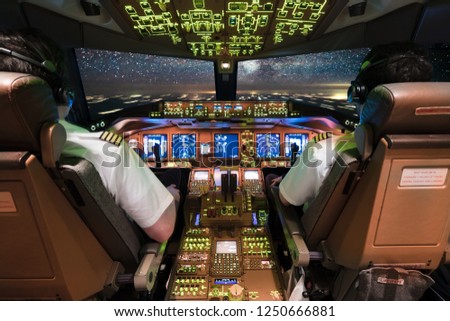 Pilots in Cockpit facing the milky way