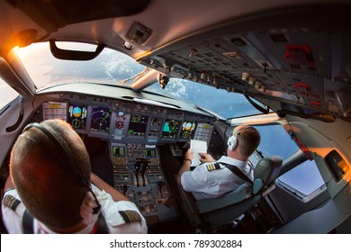 The Pilots Of The Passenger Plane At Work. View From The Aircraft Cockpit.