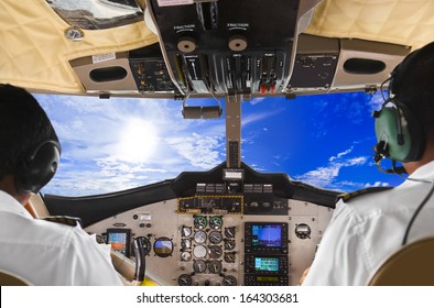 Pilots In The Plane Cockpit And Cloudy Sky